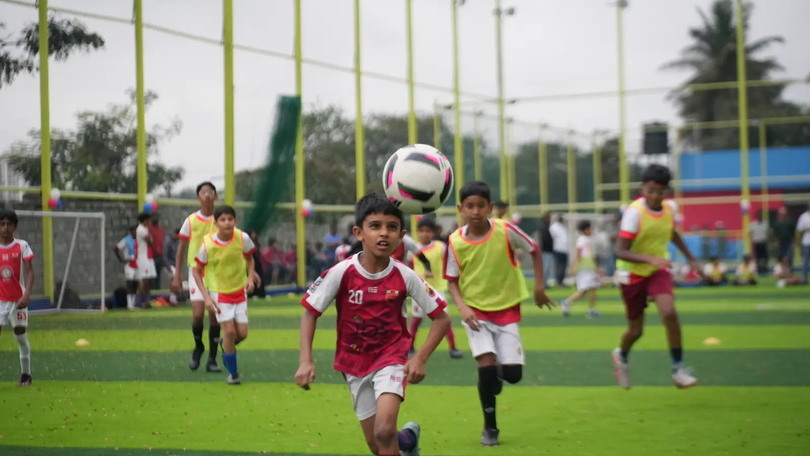 Young footballers chasing the ball during a match at Coliseo Nice Road